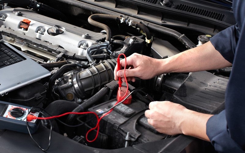 Technician doing a test on a car battery