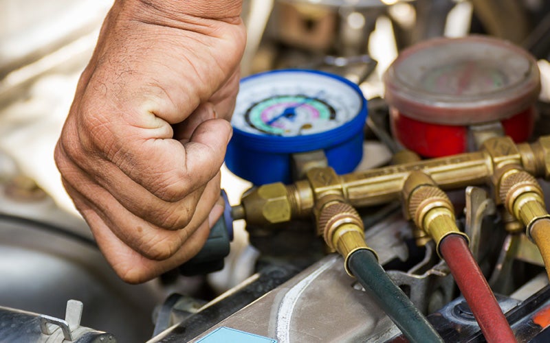 Close up on car engine gauges and hoses